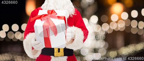 Image of close up of santa claus with christmas gift