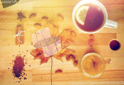 Image of cup of lemon tea and honey on wooden board