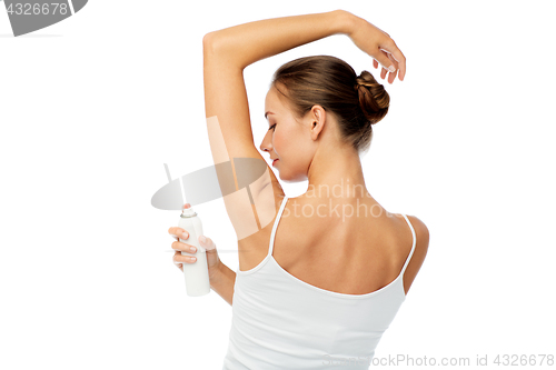 Image of woman with antiperspirant deodorant over white