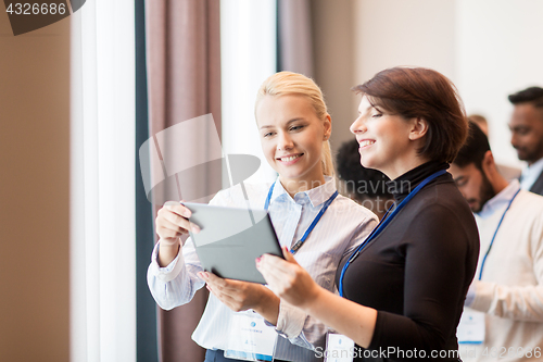 Image of team with tablet pc at business conference