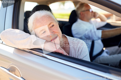 Image of happy senior couple driving in car