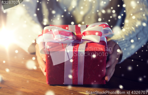 Image of close up of woman with christmas gift