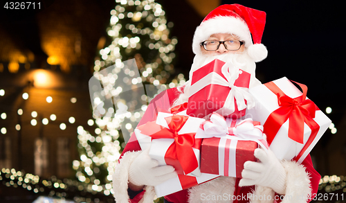 Image of close up of santa claus with christmas gifts