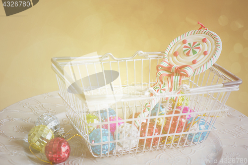 Image of Christmas decorations in shopping basket