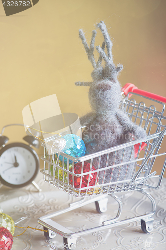 Image of Elk and others christmas toys in shopping trolley