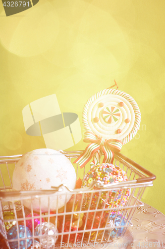 Image of Christmas balls in shopping basket, retro toned
