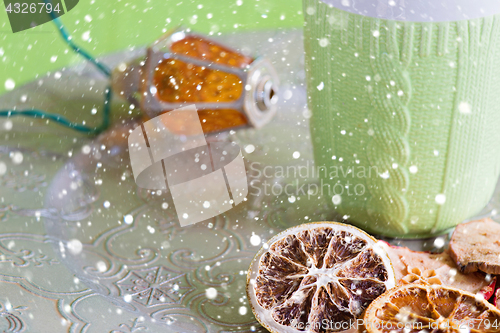 Image of Cup, christmas light bulb and cuted fruits