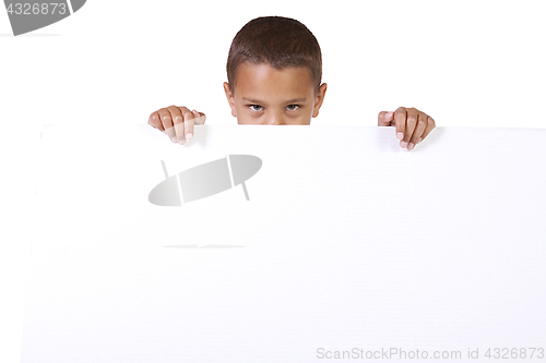 Image of Cute little boy holding a blank sign