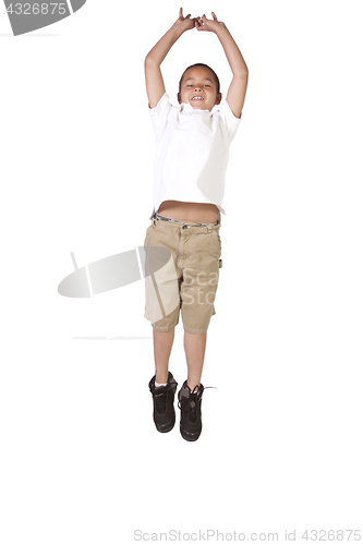 Image of Young boy jumping over white background