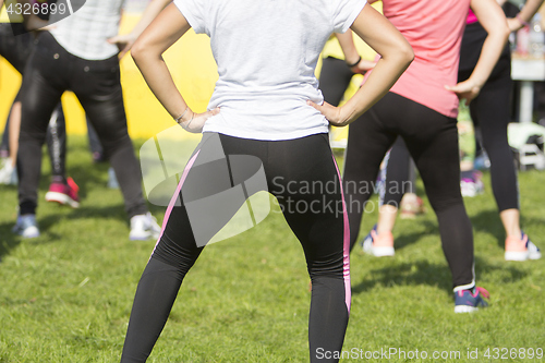 Image of Group of young girls exercising fitness with dancing in the city