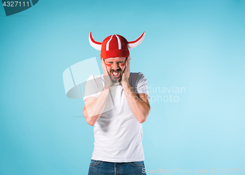 Image of The football fan over blue