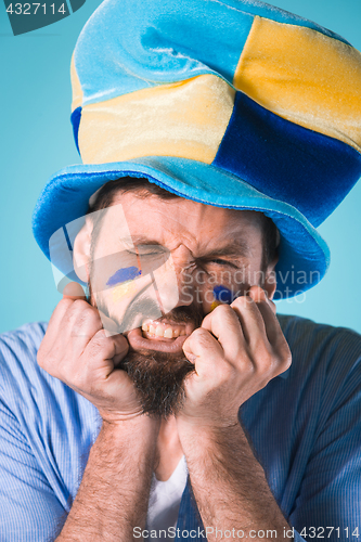 Image of The football fan over blue