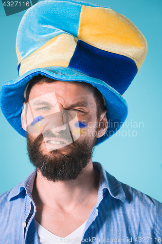 Image of The football fan over blue