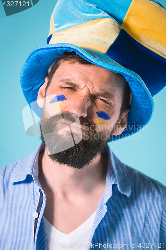 Image of The football fan over blue