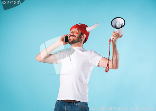 Image of The football fan over blue