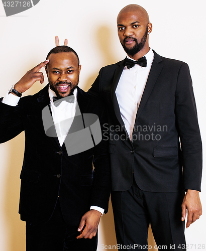 Image of two afro-american businessmen in black suits emotional posing, g