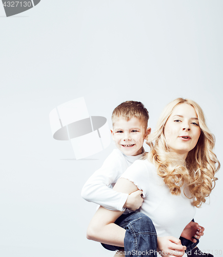 Image of young modern blond curly mother with cute son together happy smiling family posing cheerful on white background, lifestyle people concept, sister and brother friends 