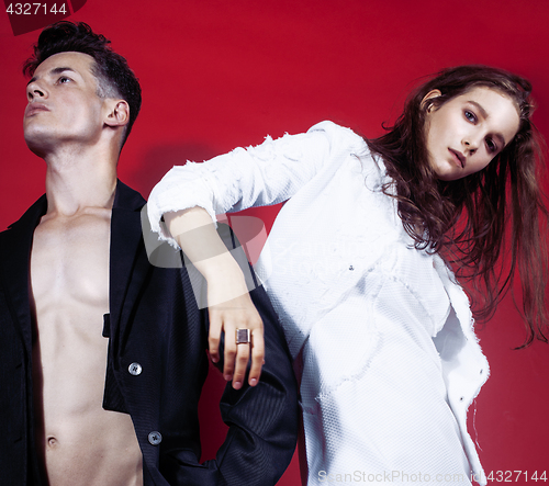 Image of young fashion style couple man and woman on red sexy background, luxury stuff, lifestyle modern people sale concept 