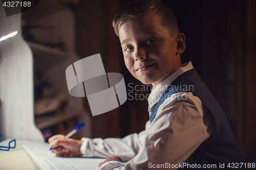 Image of pupil boy does his homework