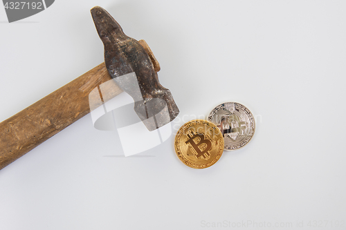 Image of Bitcoin coins with hammer