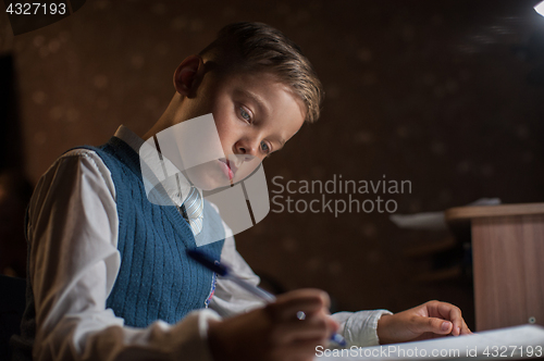 Image of pupil boy does his homework