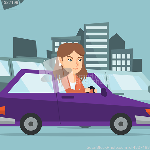 Image of Angry caucasian woman in car stuck in traffic jam.