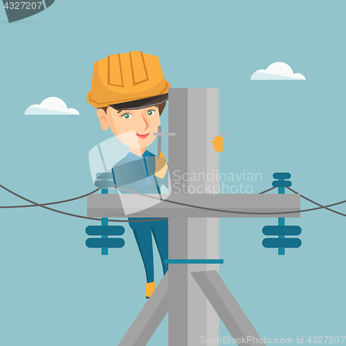 Image of Electrician working on electric power pole.