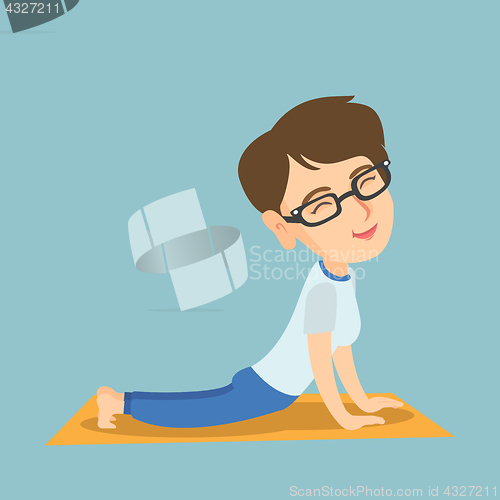 Image of Caucasian woman practicing yoga upward dog pose.