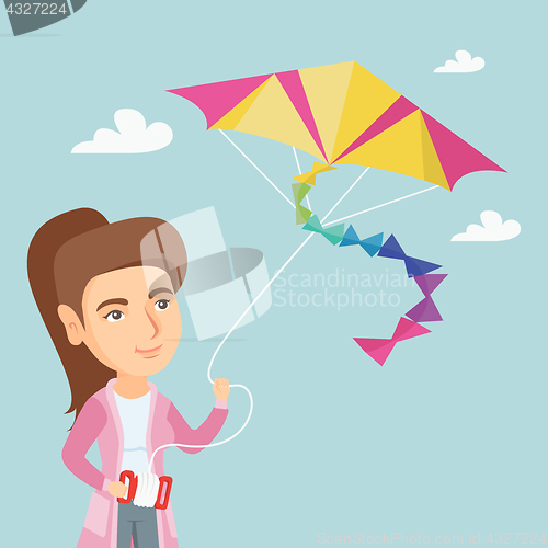 Image of Young caucasian woman flying kite.