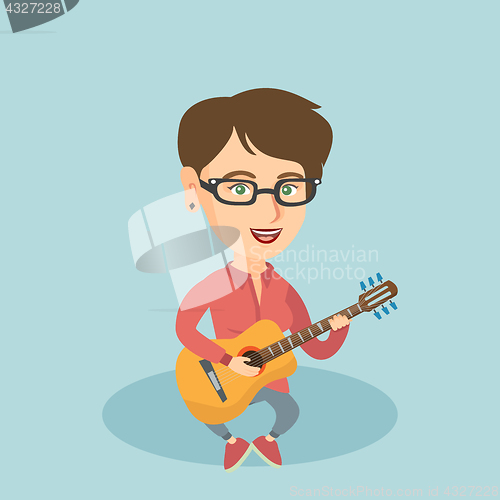 Image of Young caucasian woman playing the acoustic guitar.