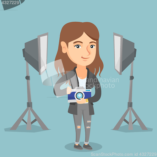 Image of Photographer with camera in the photo studio.