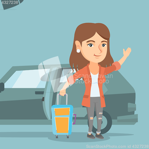 Image of Young caucasian woman waving in front of car.