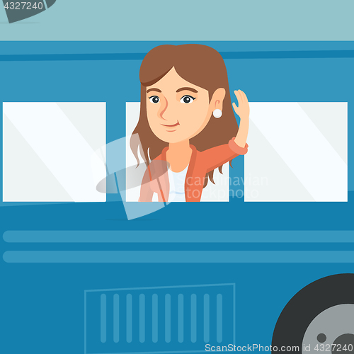Image of Young caucasian woman waving hand from bus window.