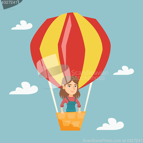 Image of Young caucasian woman flying in hot air balloon.