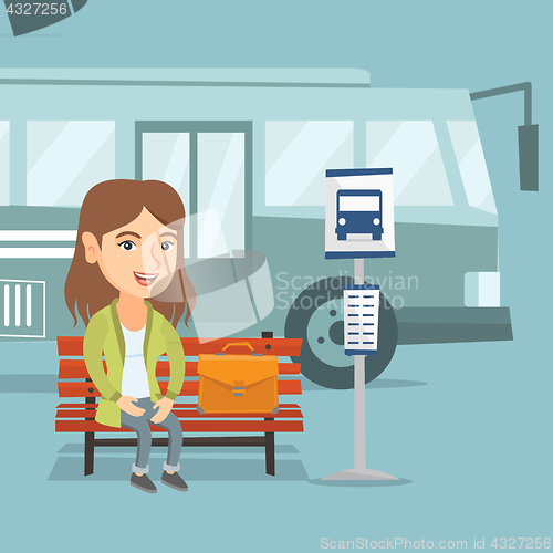 Image of Caucasian woman waiting for a bus at the bus stop.