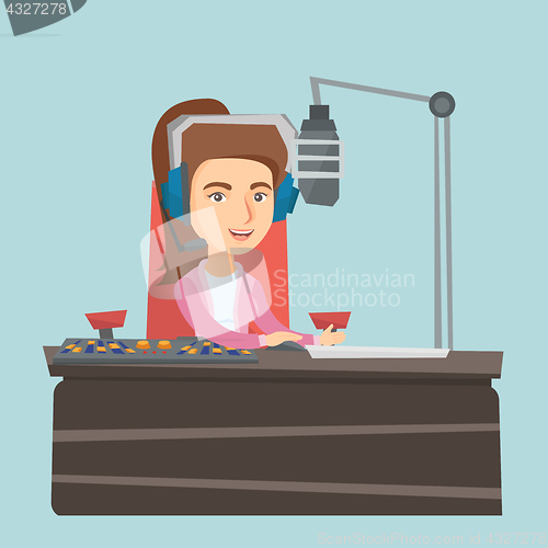 Image of Young female caucasian dj working on radio.