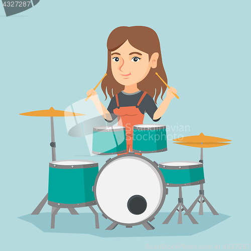 Image of Young caucasian woman playing the drum.