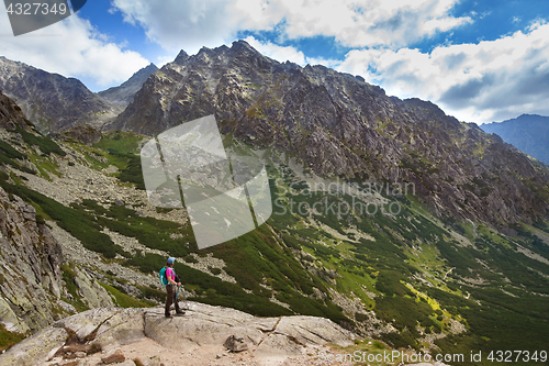 Image of Hiking woman admiring the beauty of rocky Tatra mountains