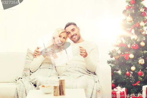 Image of happy couple at home with christmas tree