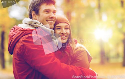 Image of happy young couple hugging in autumn park