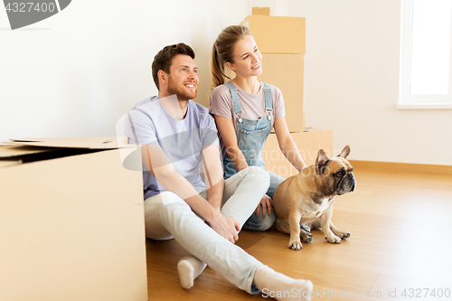 Image of happy couple with boxes and dog moving to new home