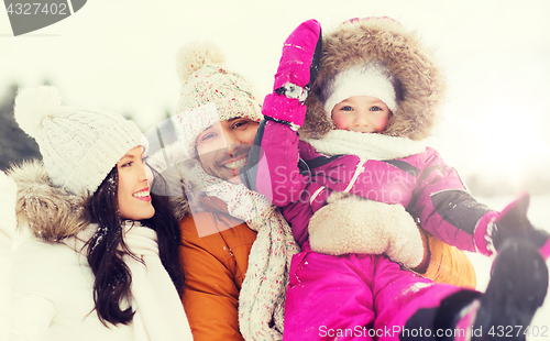 Image of happy family with child in winter clothes outdoors