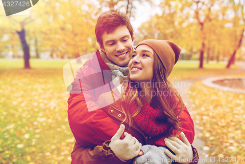 Image of happy young couple hugging in autumn park