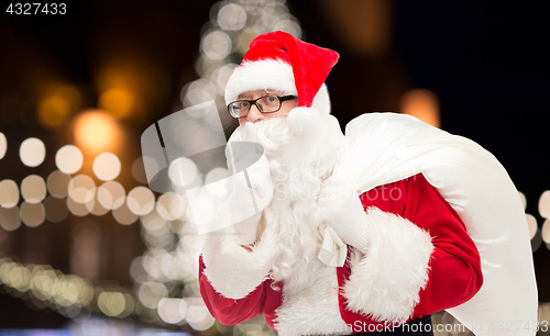 Image of man in costume of santa claus with bag