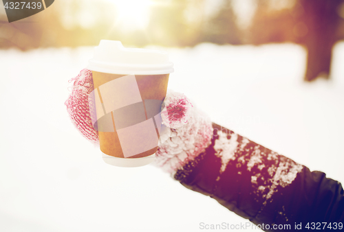 Image of close up of hand with coffee outdoors in winter