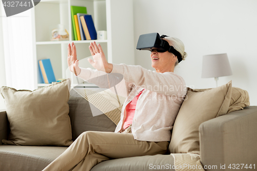 Image of old woman in virtual reality headset or 3d glasses