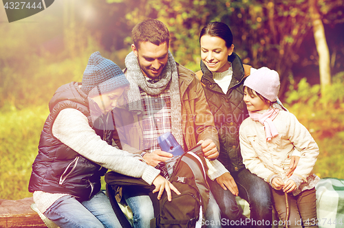 Image of happy family with backpack and thermos at camp