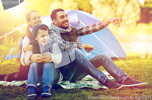 Image of happy family with tent at camp site