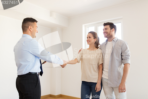 Image of man and realtor shaking hands at new home