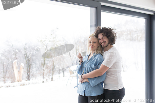 Image of young couple enjoying morning coffee by the window